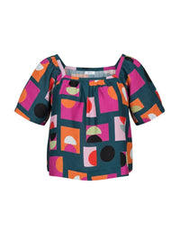 Colorful geometric patterned top on a white background