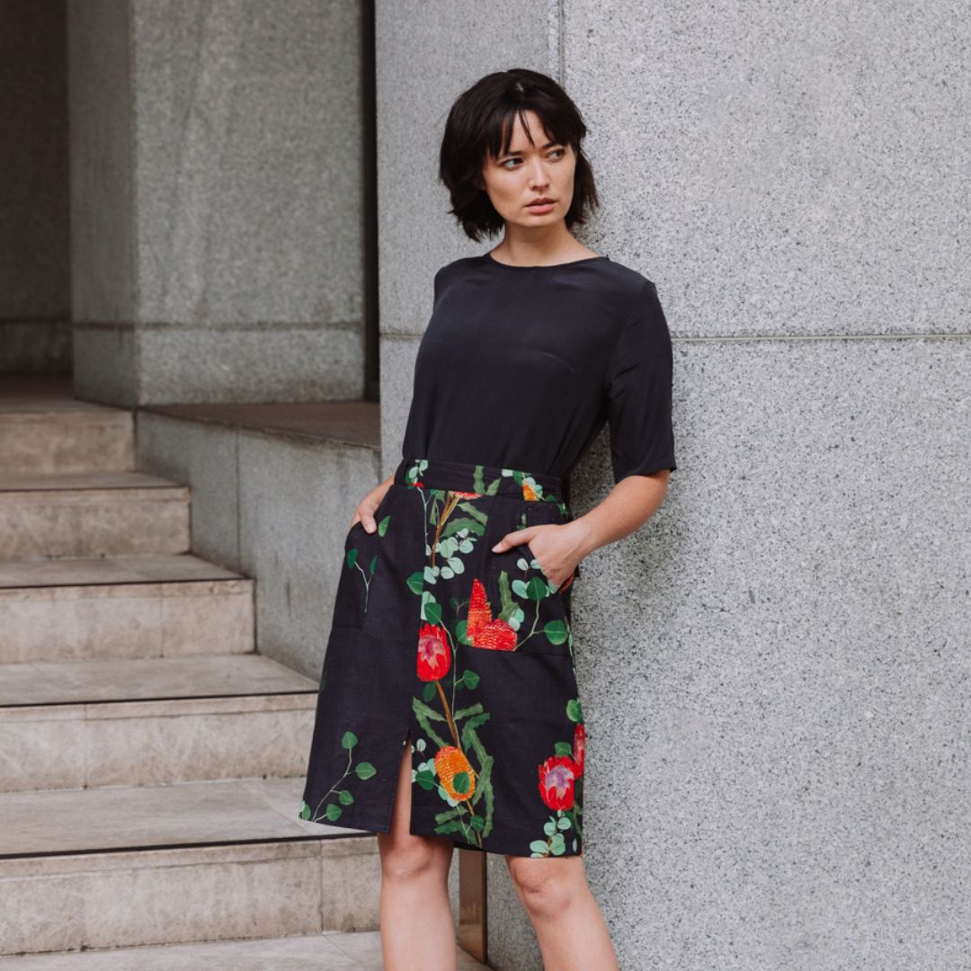 Model wearing a black DEOVI printed linen skirt