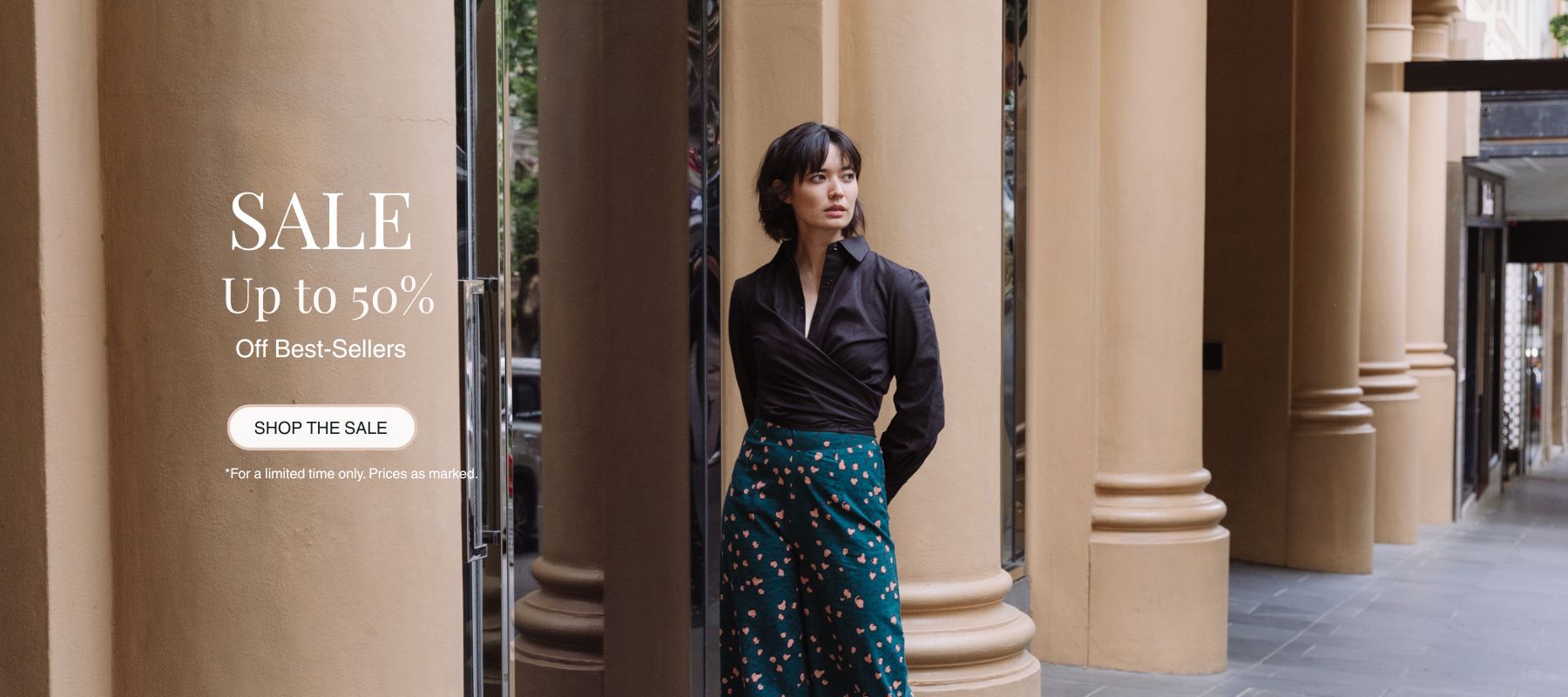 Woman standing in front of classical architecture with sale banner on the left