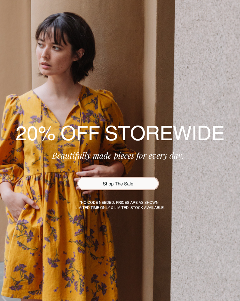 Woman in a yellow dress standing against a neutral wall with promotional text overlay.