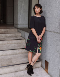 Model wearing a DEVOI black Lise top in plain black silk crepe. Front view on model