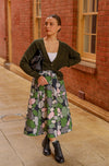Printed linen skirt in a green pebbles print. Midi length with pocket and an elasticated waistband. Front view