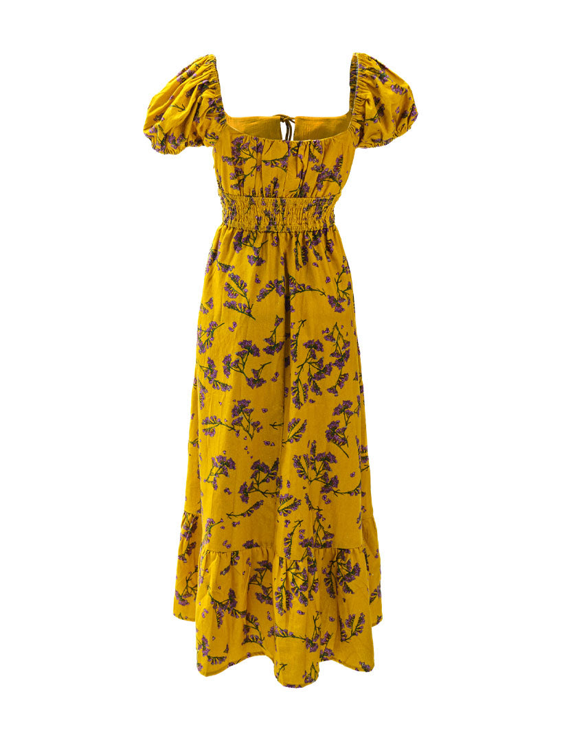 DEVOI Keira dress in Scalavender printed Modal crepe. Smocked bodice and a square neckline, puff sleeves, and with a maxi tiered skirt. Back view.