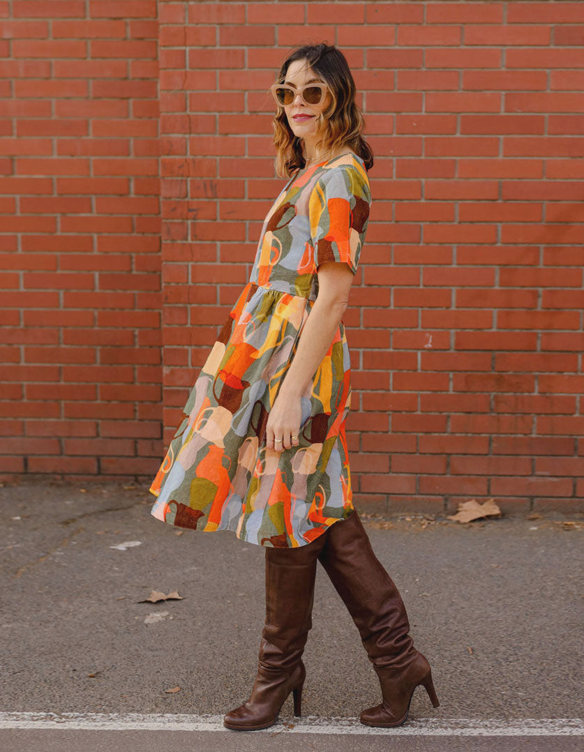 DEVOI Dorothy dress in cotton cord. Printed in Jugs print. Orange and grey colours. Round neckline and gathering at the waist. Side view