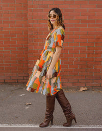 DEVOI Dorothy dress in cotton cord. Printed in Jugs print. Orange and grey colours. Round neckline and gathering at the waist. Side view