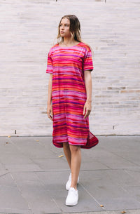DEVOI Madeleine dress in Sunset tide print. 100% Organic cotton jersey. pink hand painted print. Designed in melbourne. Short sleeves and side pockets.  Full view