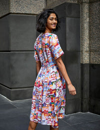 DEVOI White Urban Scapes Dorothy dress in printed Linen. Round neckline. Knee length. Short sleeves. Pockets. Back close view on model.