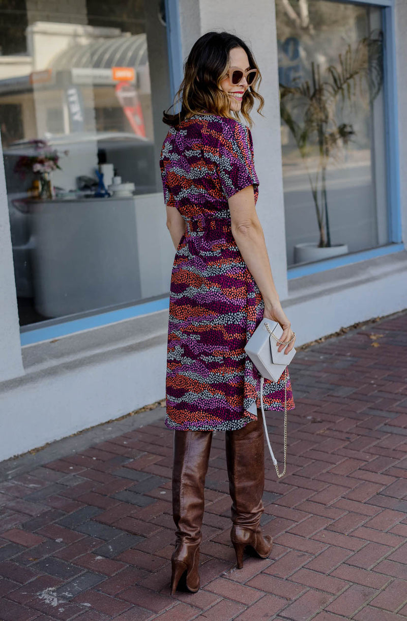 DEVOI Annie dress with a round neckline in Black Sediment print. Black, pink orange and plum colours. Shift dress with a tie belt at the waist. The dress has pockets. Back view