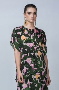 DEVOI Cate top in Purple Calla Lilies printed cupro, vegan silk. Green and floral print. Floaty blouse with a round neck collar and hidden button placket.