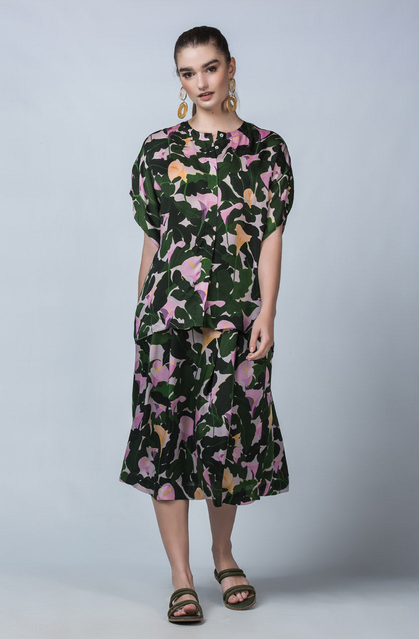 DEVOI Cate top in Purple Calla Lilies printed cupro, vegan silk. Green and floral print. Floaty blouse with a round neck collar and hidden button placket.