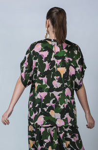 DEVOI Cate top in Purple Calla Lilies printed cupro, vegan silk. Green and floral print. Floaty blouse with a round neck collar and hidden button placket.