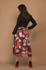 DEVOI Kathleen skirt in our maroon Block Party printed linen. The skirt has an elasticated back waistband and front drawstring tie. The skirt is a midi length and has pockets.