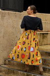 DEVOI Kathleen skirt in new print Mustard Sauros. Elastic waist and pockets. Skirt falls just below the knee. Drawstring tie at front waist.  Back view