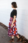 DEVOI Kathleen skirt in our maroon Block Party printed linen. The skirt has an elasticated back waistband and front drawstring tie. The skirt is a midi length and has pockets.